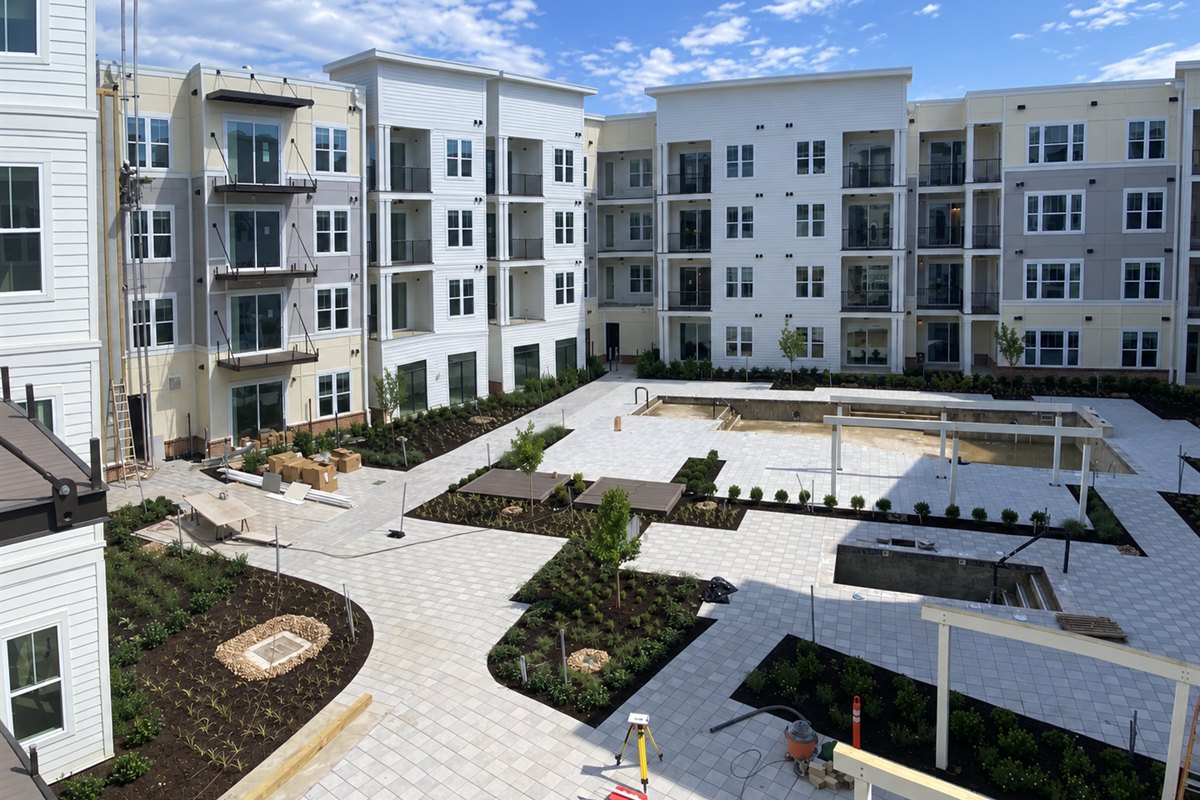 Paver courtyard, planting beds and pergola installation at a multifamily community
