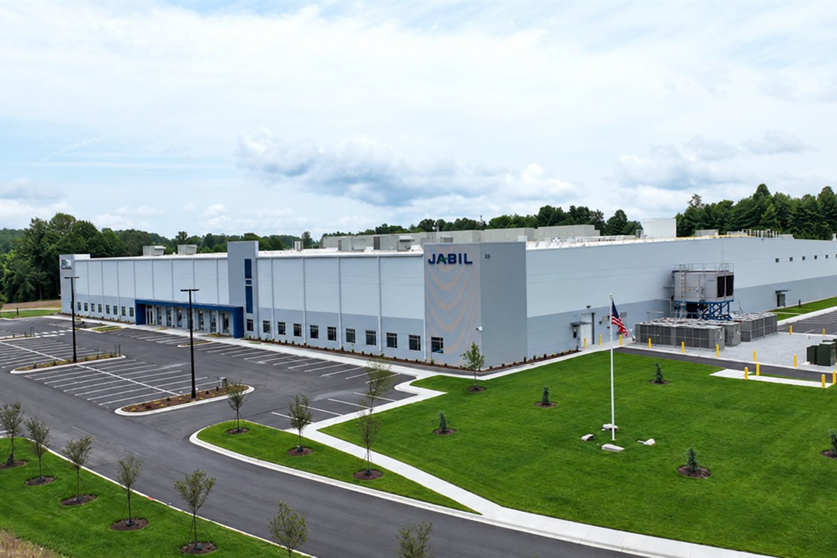 Lawn, parking-lot islands and new trees at a manufacturing campus