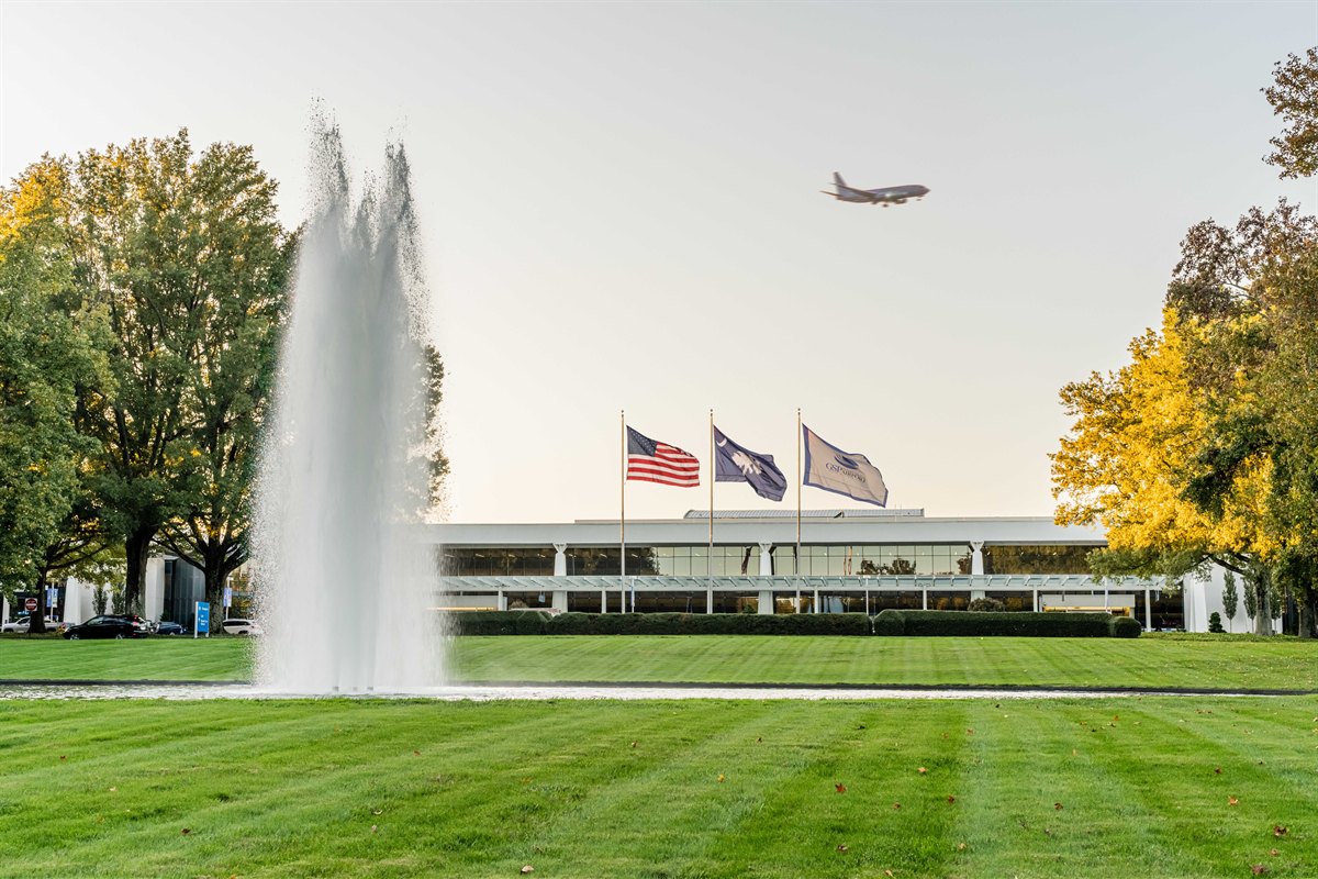 Striped turf, hedges and fountain at an airport terminal entrance