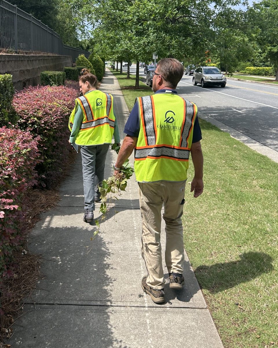 Granite Hills team members walking a landscaped property.