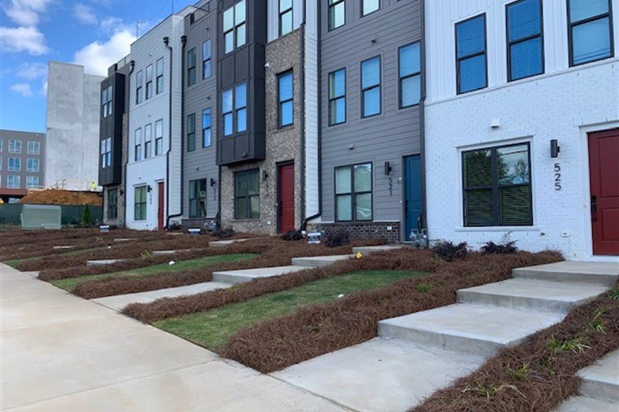 Landscaped entry walk at a multifamily townhome community