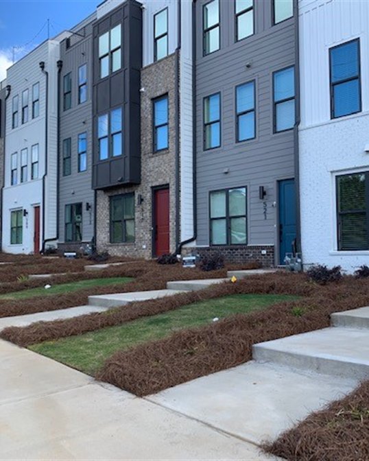 Landscaped entry walk at a multifamily townhome community