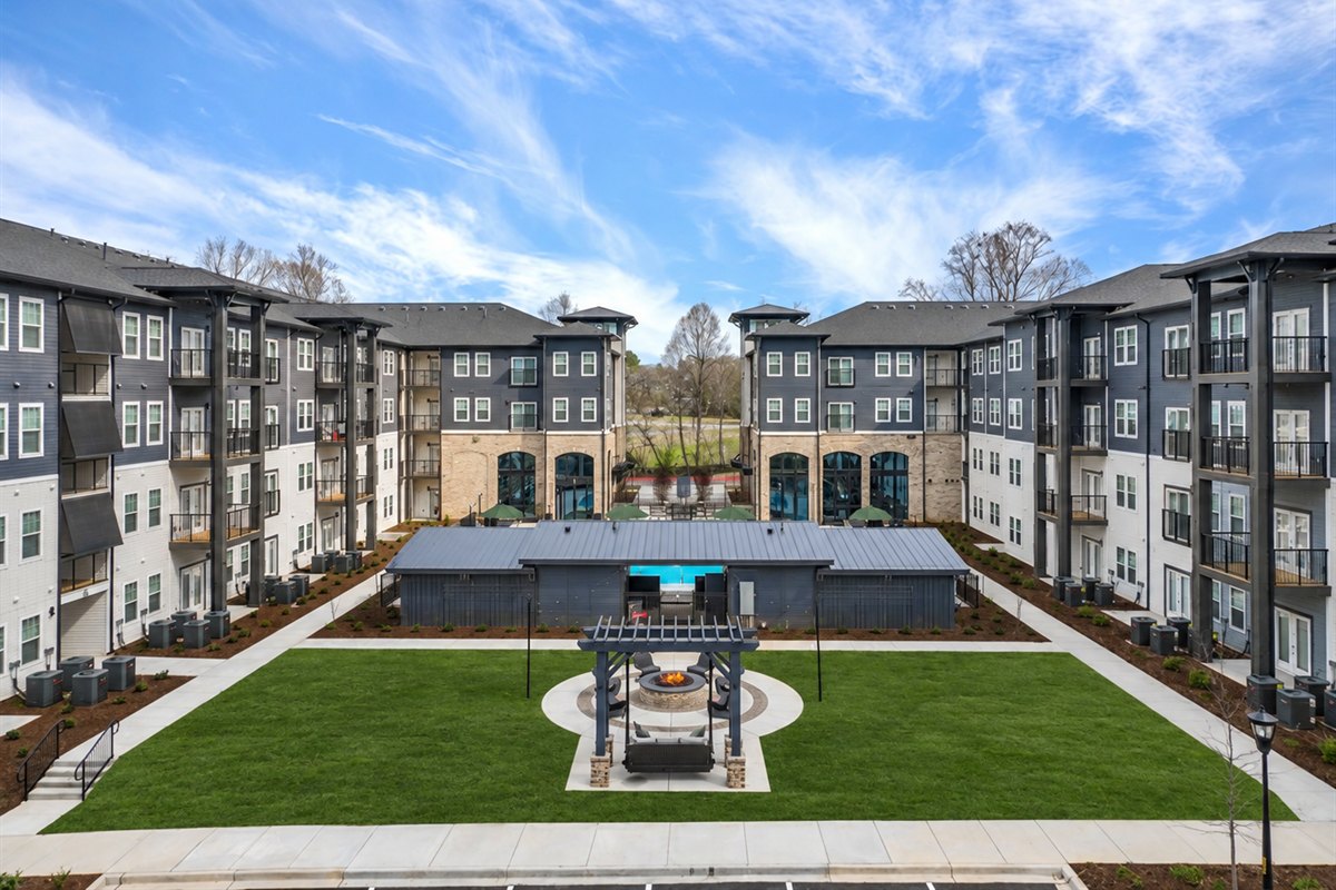 Resident courtyard lawn and fire pit pergola at a multifamily community