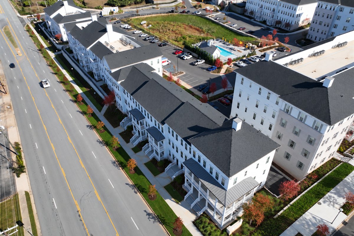 Aerial view of a multifamily community frontage with street trees and planting strips