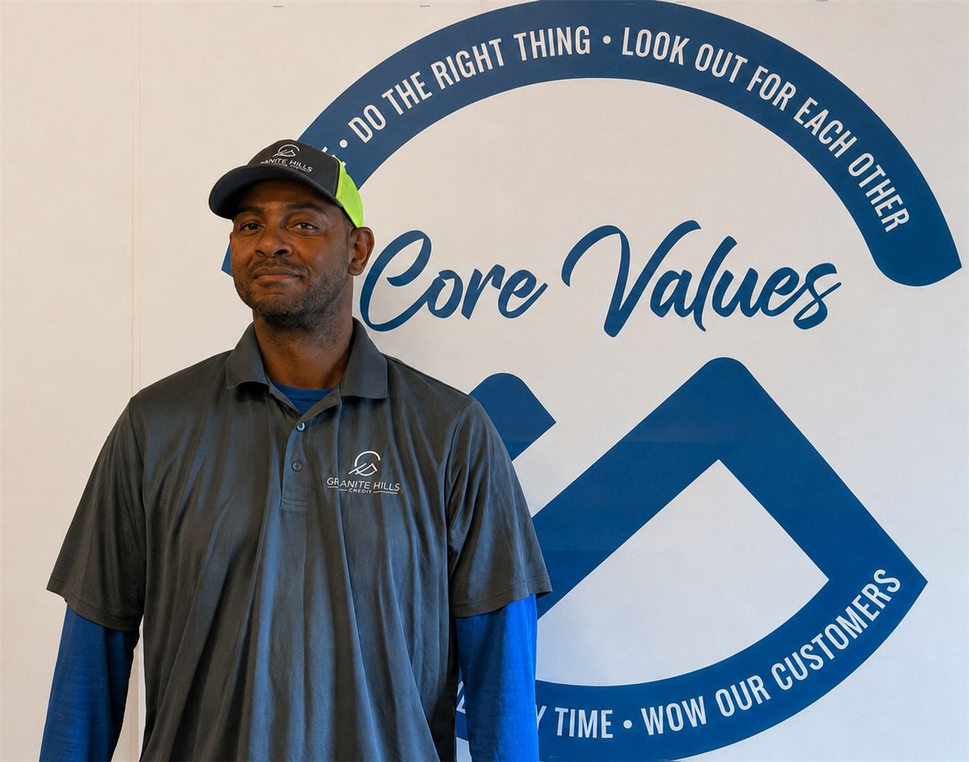Rodney Thomas in front of the Granite Hills Core Values wall