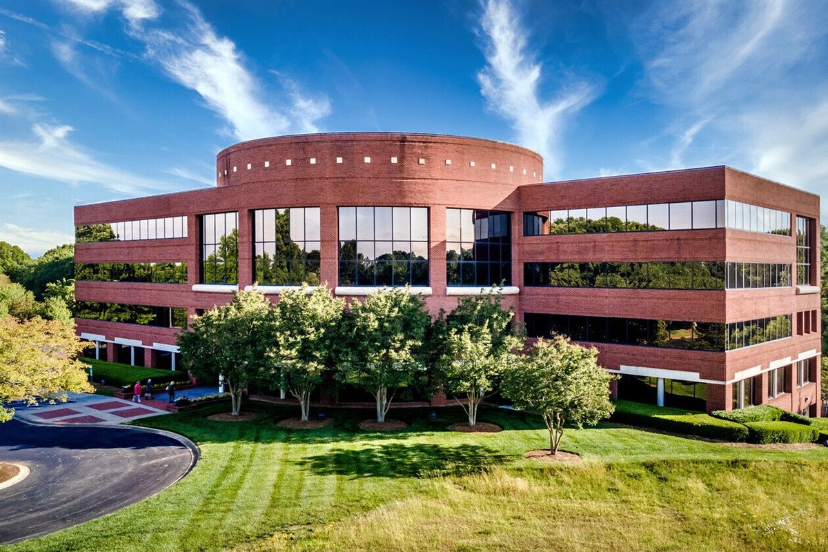 Striped turf, ornamental trees and hedges at a suburban office building