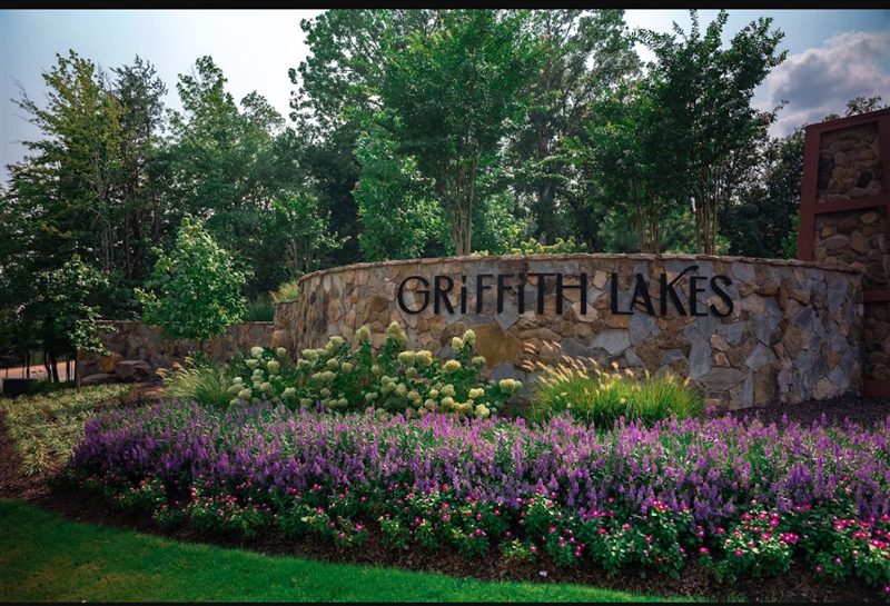 Maintained commercial grounds with mowed turf and shaped shrub beds