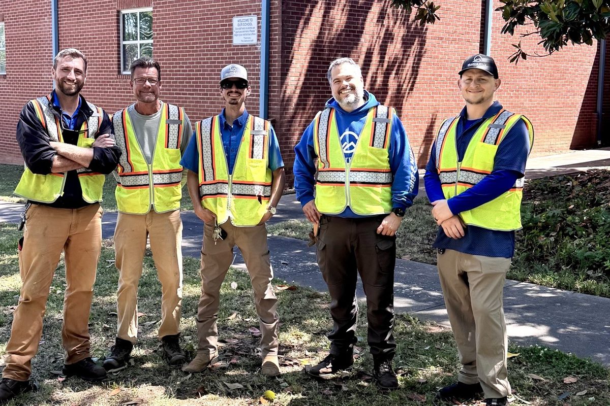 Five Granite Hills team members standing together outdoors.